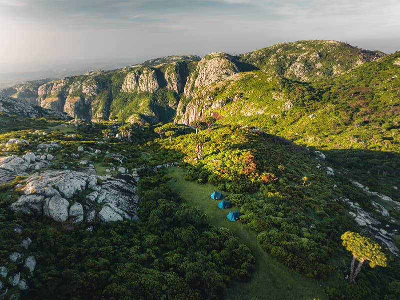 A person on a swing on a pristine Australian beach with turquoise water.
